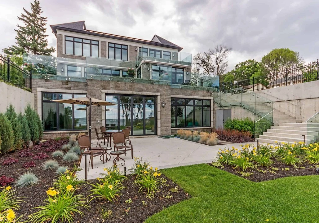 A modern home with a large yard and patio.
