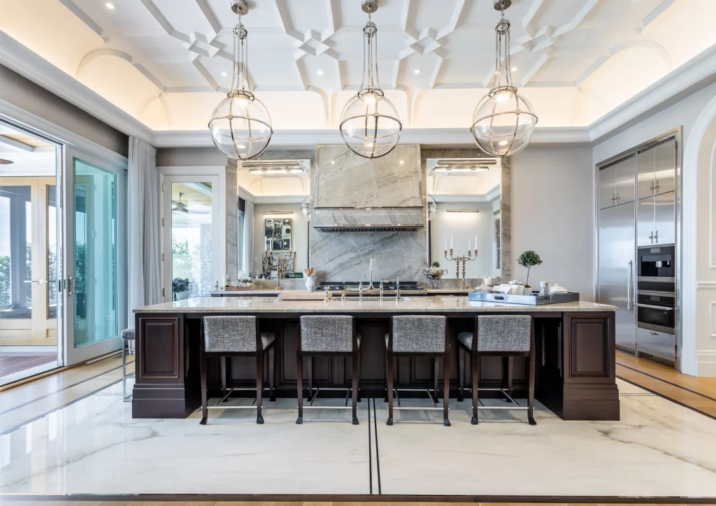 A large kitchen with marble counter tops and a marble island in an east oakville lakefront property.