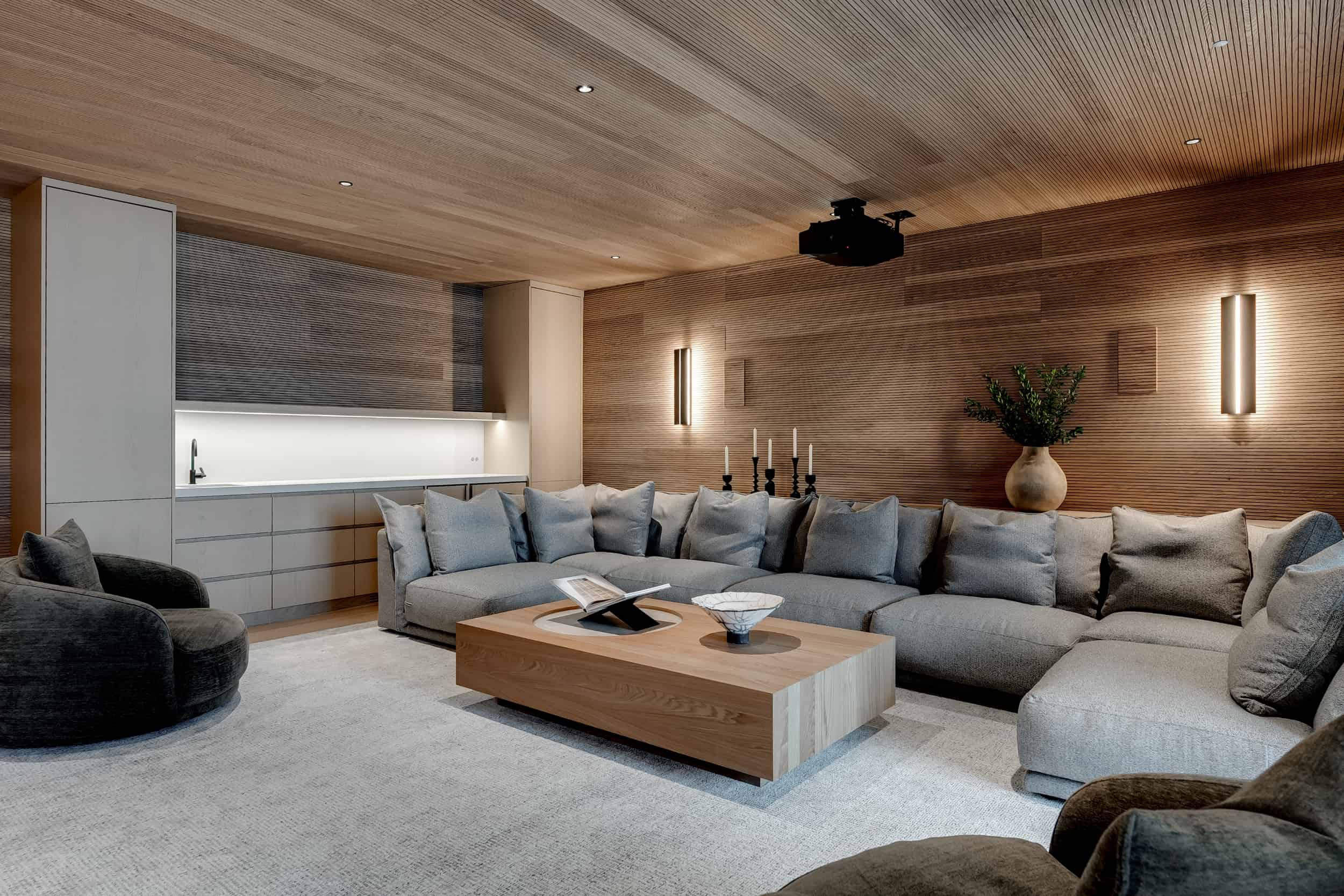 A modern living room with wood paneled walls in a west oakville lakefront setting, luxury custom home