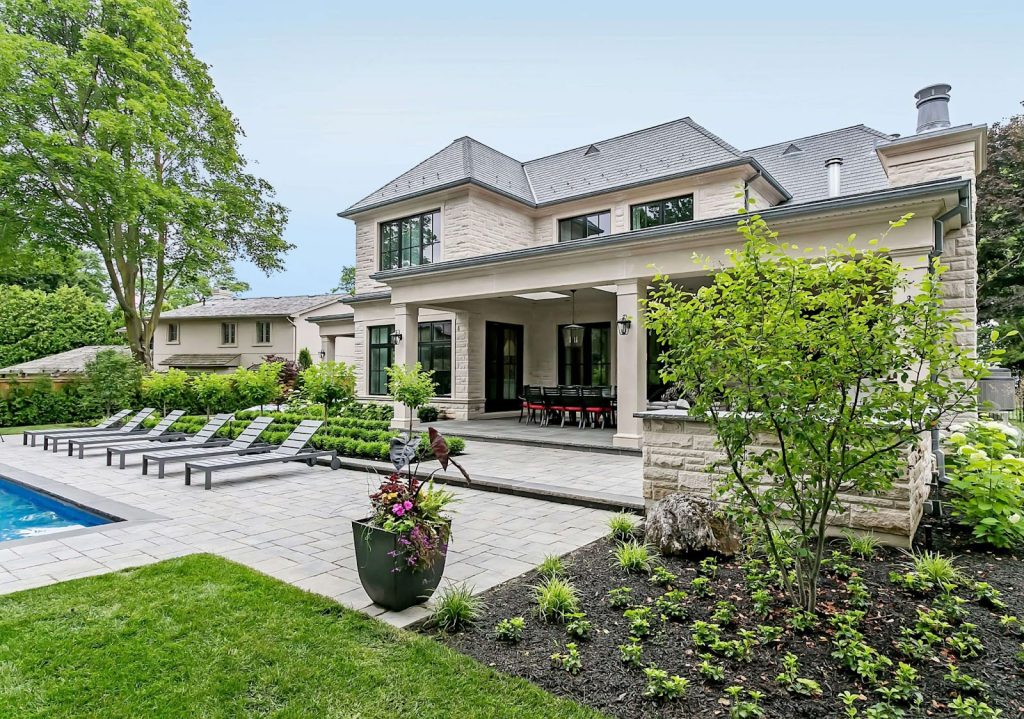 Modern luxury home exterior showcasing sleek architecture, large windows, and landscaped surroundings, representing a New House Development in Oakville.